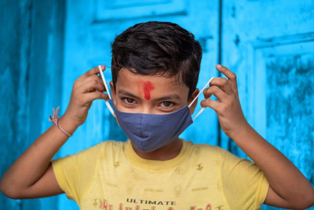 Un enfant portant son cache-nez anti-coronavirus